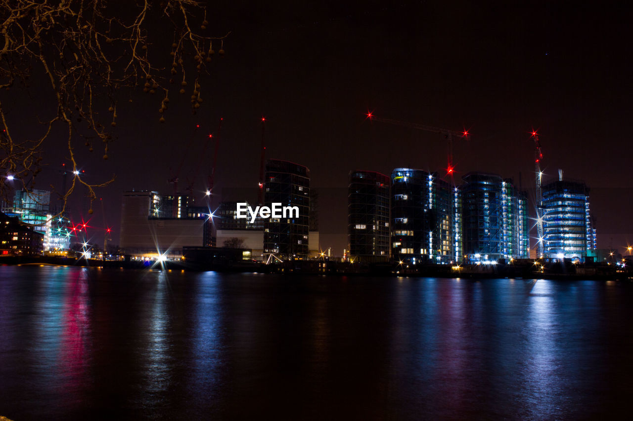 VIEW OF ILLUMINATED CITY AT NIGHT