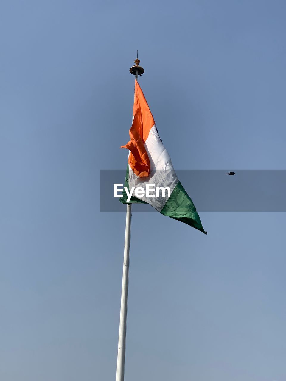 Low angle view of flag against blue sky