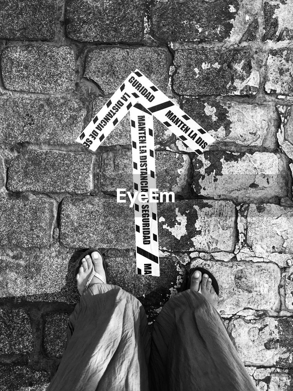 LOW SECTION OF MAN WITH TEXT WRITTEN ON SIGN