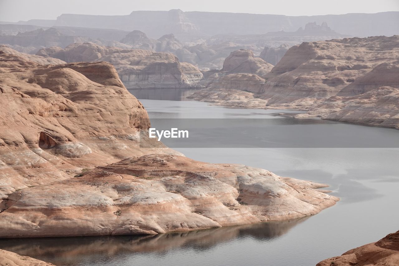 Scenic view of lake and mountains against sky