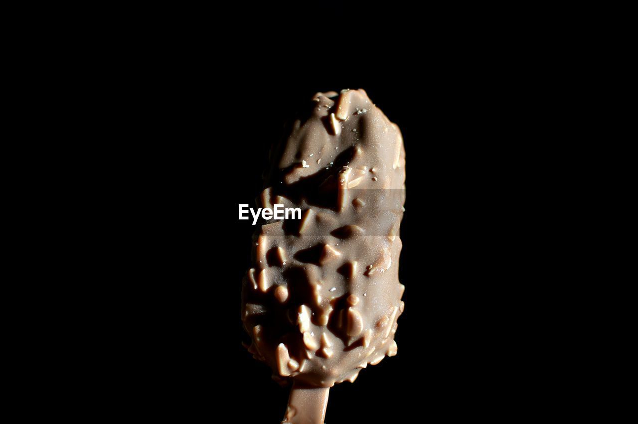 CLOSE-UP OF ICE CREAM ON BLACK BACKGROUND