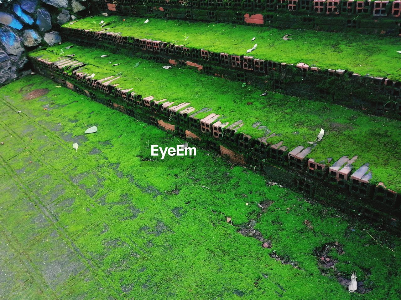 HIGH ANGLE VIEW OF RAILROAD TRACK AMIDST GRASSY FIELD