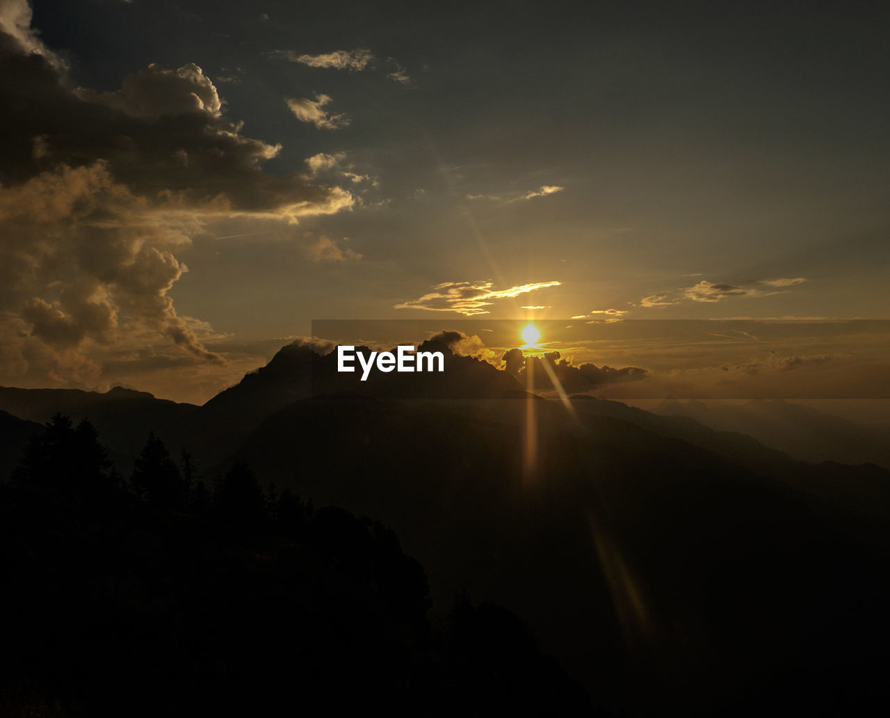 SILHOUETTE OF MOUNTAIN AGAINST SKY DURING SUNSET