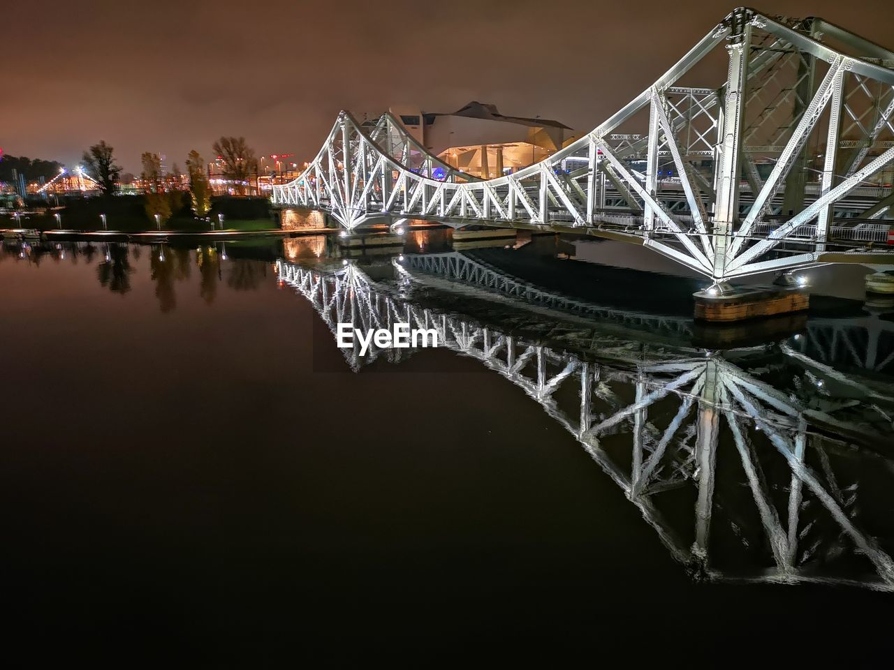 ILLUMINATED BRIDGE OVER RIVER