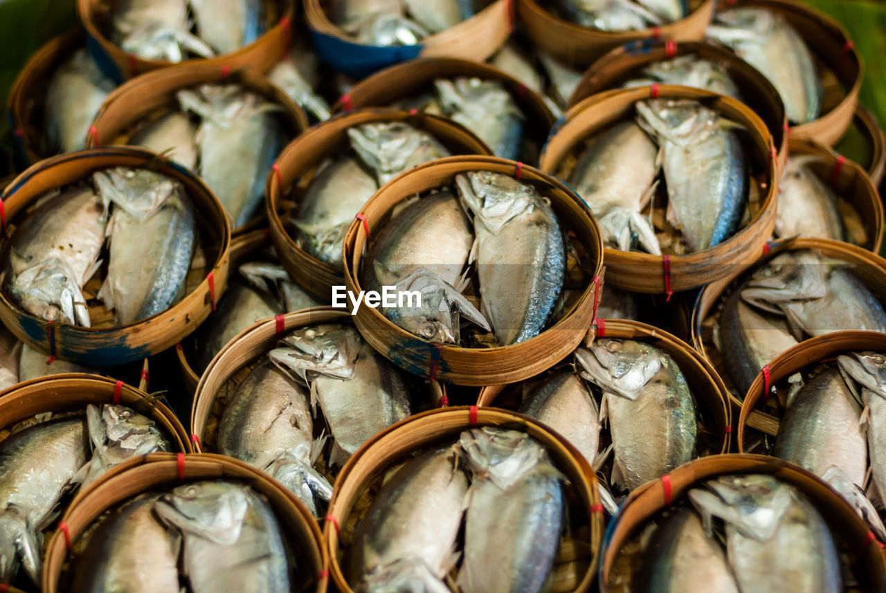 Full frame shot of fishes in baskets at market for sale