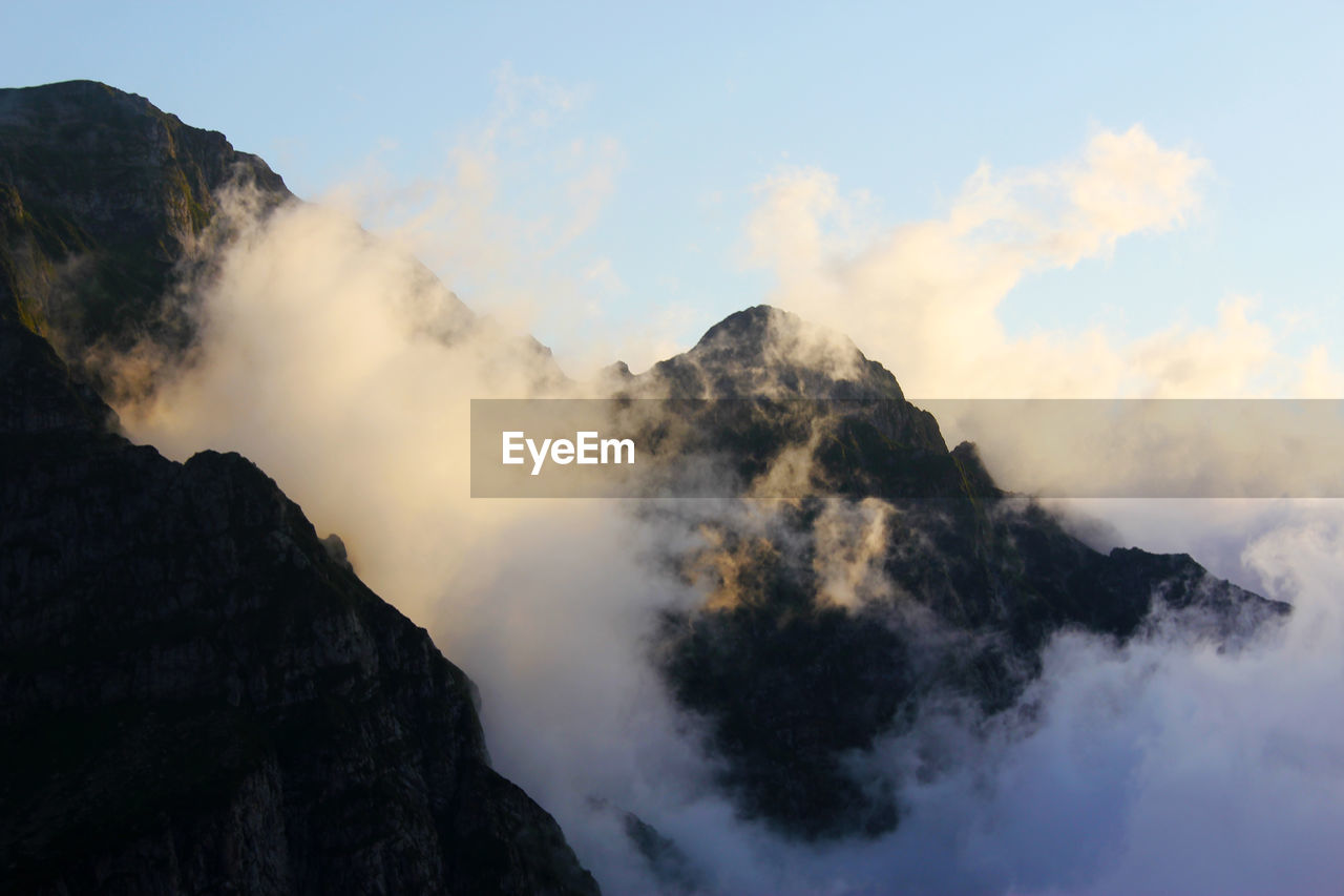 Low angle view of mountain range against sky