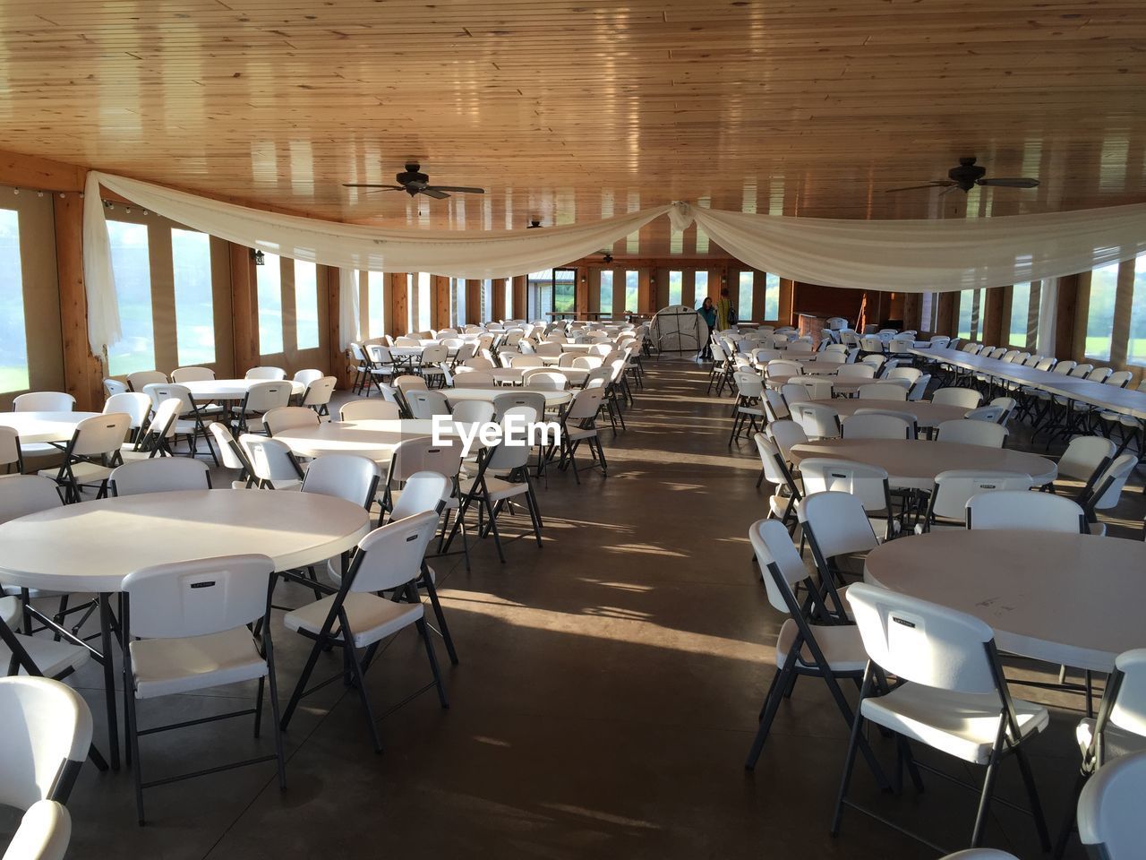 HIGH ANGLE VIEW OF EMPTY CHAIRS AND TABLES IN RESTAURANT