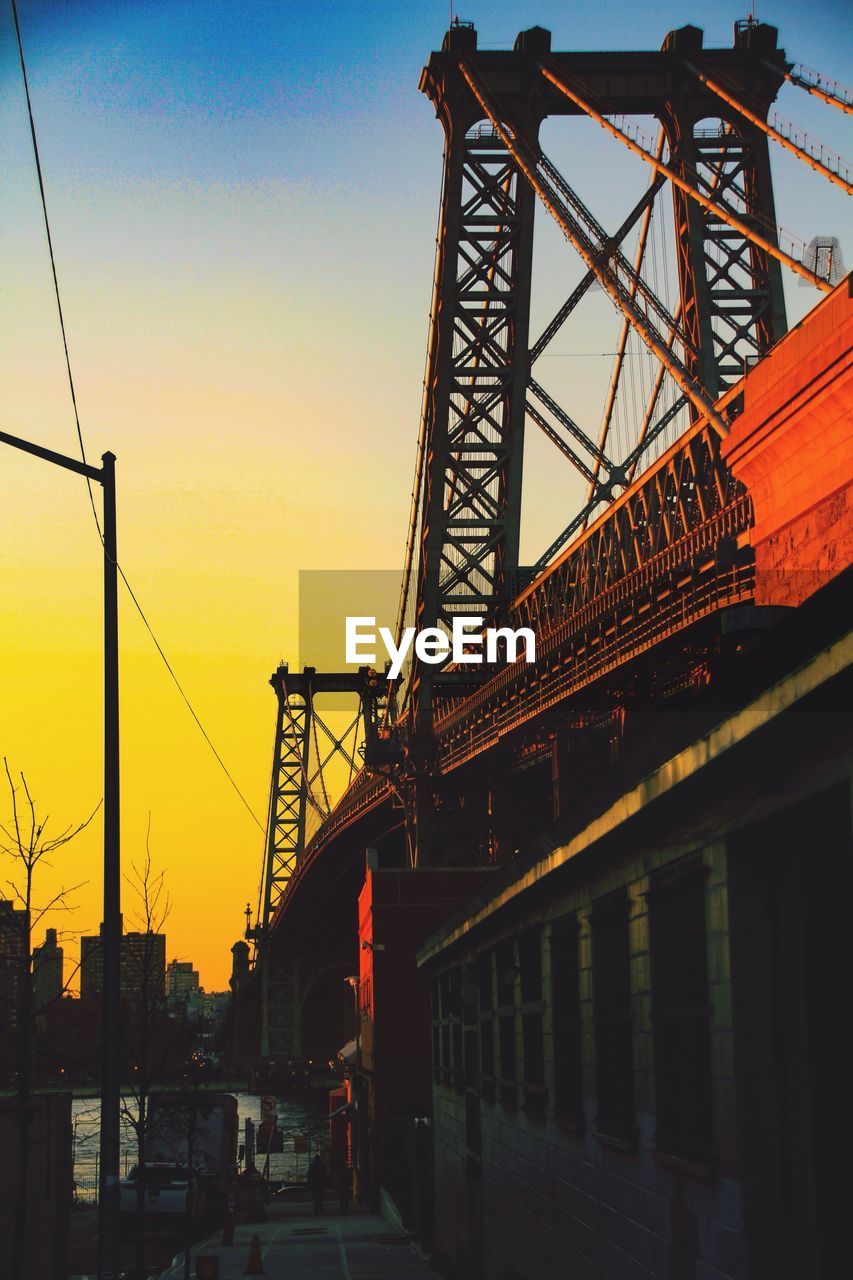 Low angle view of williamsburg bridge against clear sky during sunset