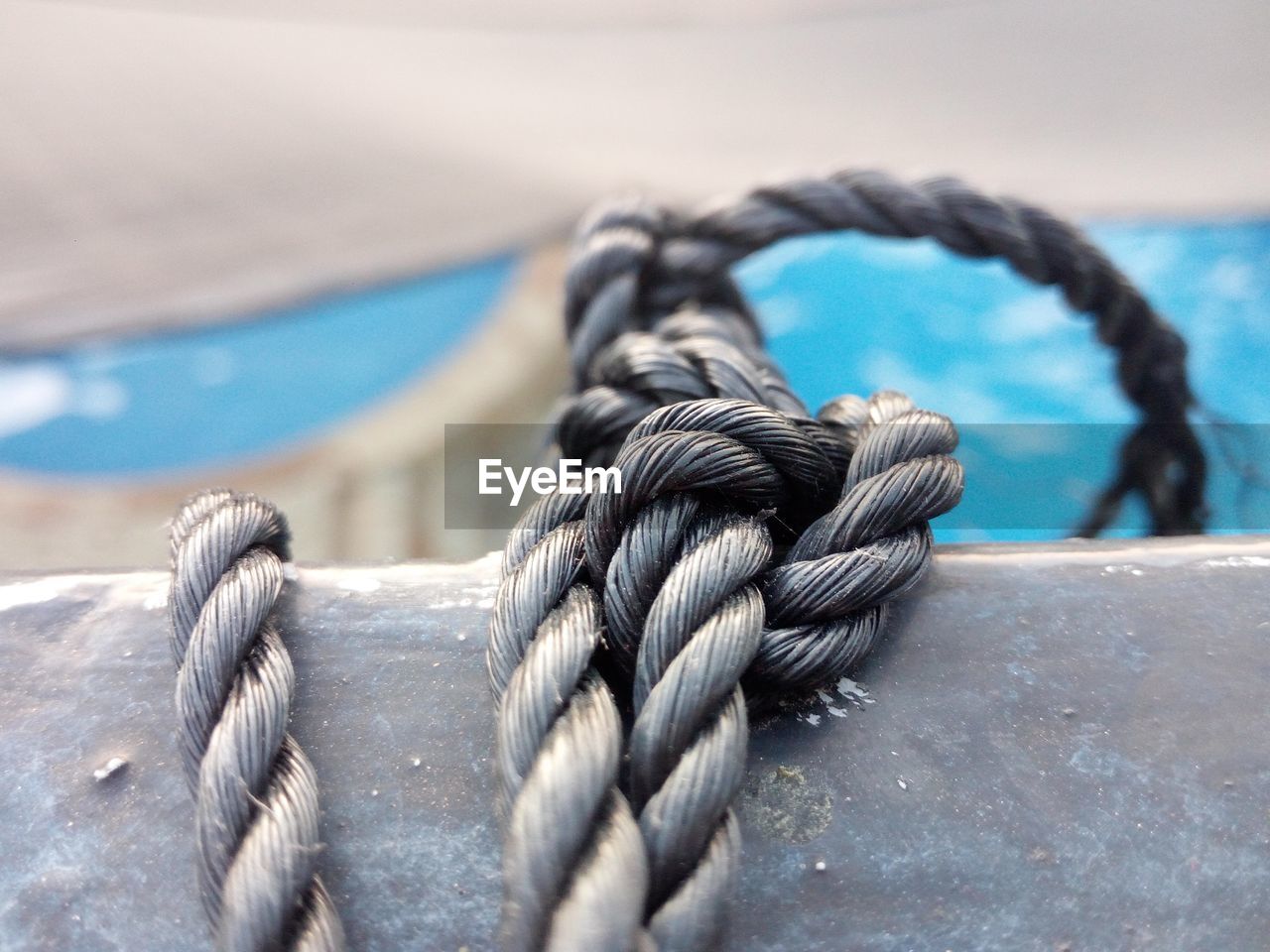 Close-up of rope tied to railing on boat