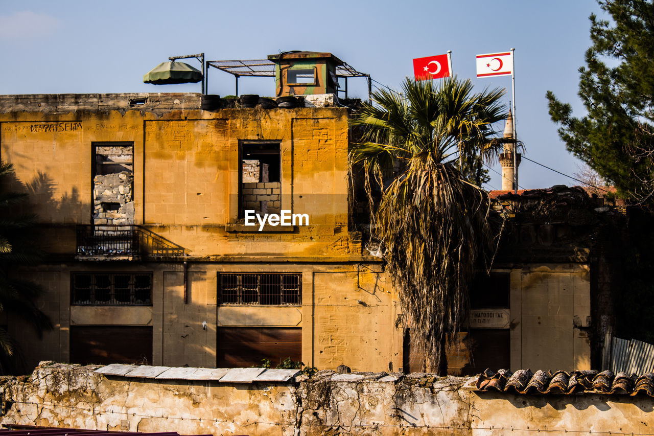 urban area, architecture, built structure, building exterior, wall, town, house, nature, building, no people, communication, ancient history, abandoned, damaged, sky, day, sign, outdoors, tree, city, plant, history, residential district, street, old, ruined, rundown, road