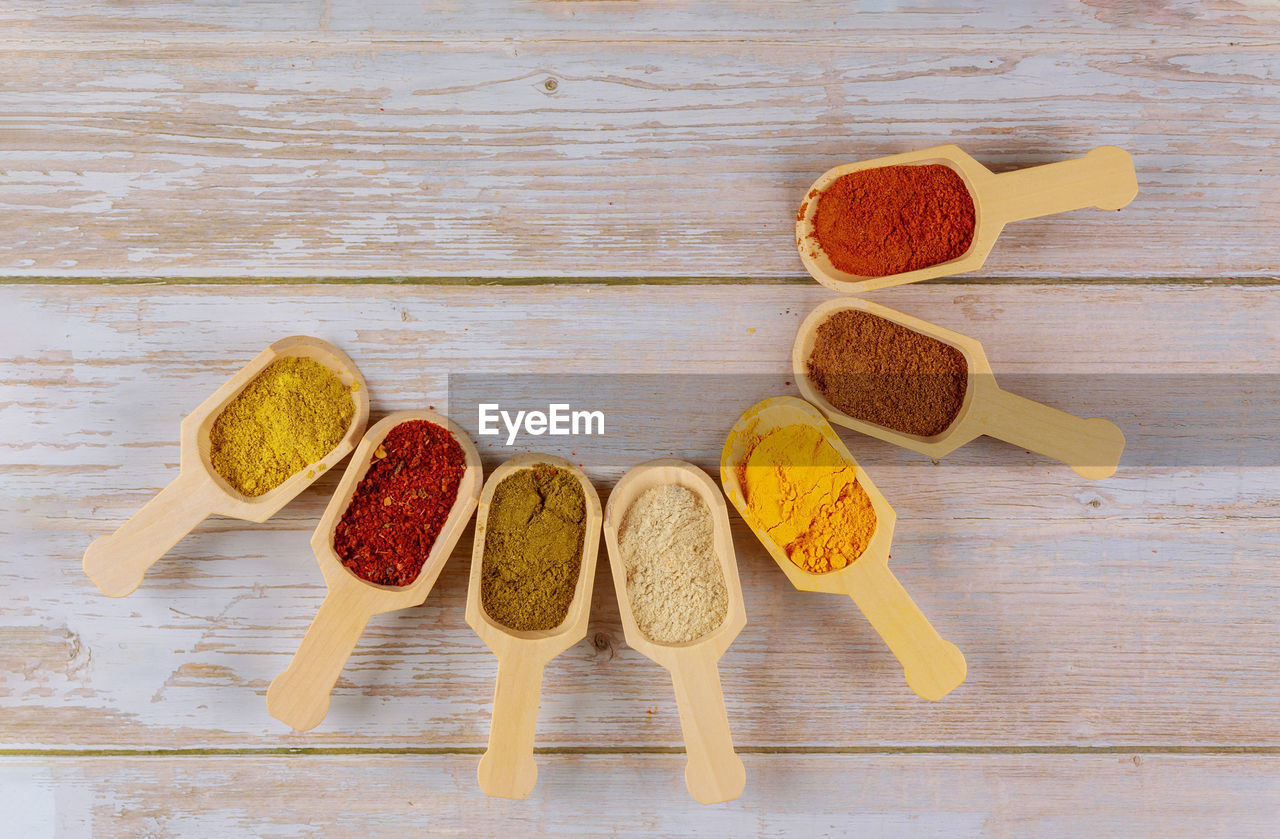 High angle view of various spices in spoons on table