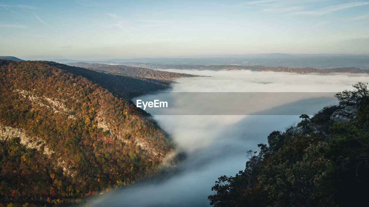 High angle view of sea and mountains against sky