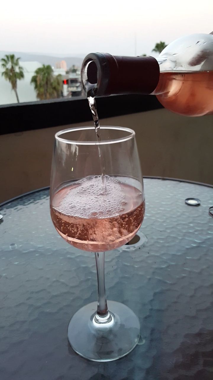 CLOSE-UP OF BEER GLASS ON TABLE