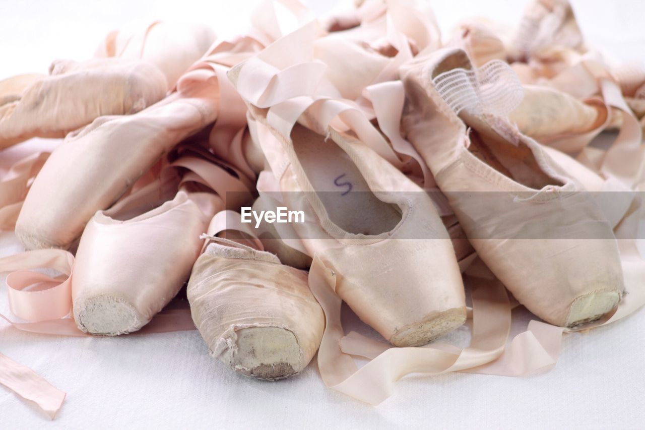 Close-up of damaged ballet shoes on table