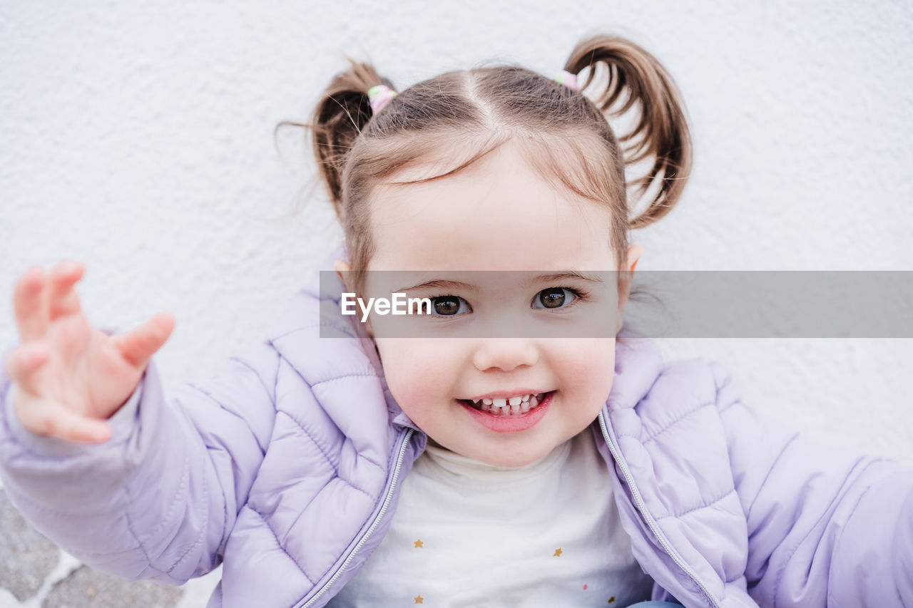 Portrait of beautiful caucasian two year old baby girl smiling over white background. childhood