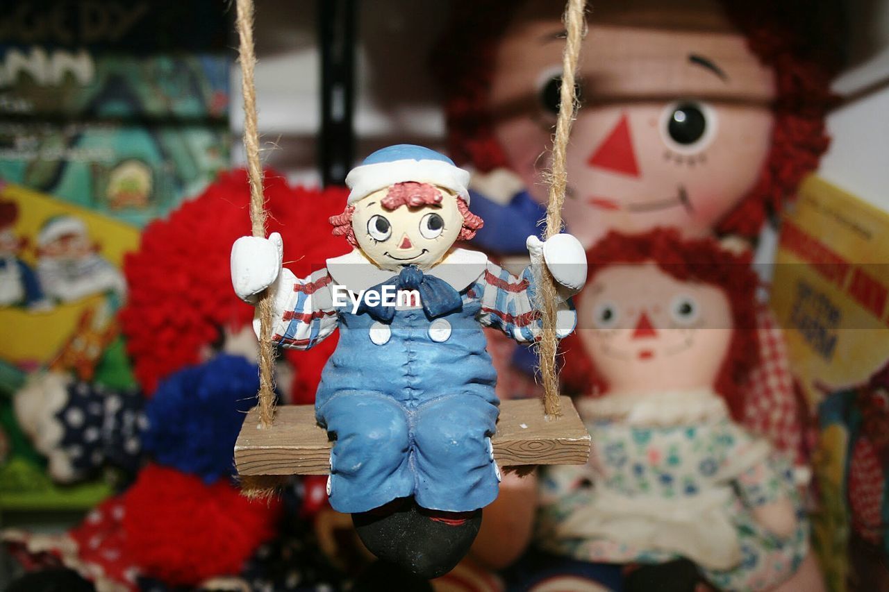 Close-up of toy sitting on swing