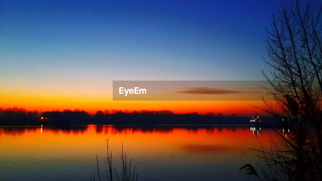 SCENIC VIEW OF LAKE AGAINST ROMANTIC SKY