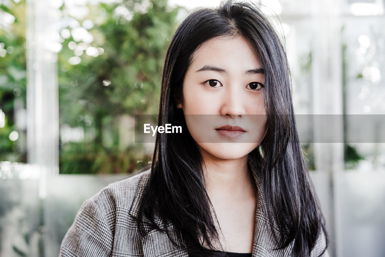 Portrait of confident professional chinese entrepreneur woman in cafeteria. technology, lifestyle