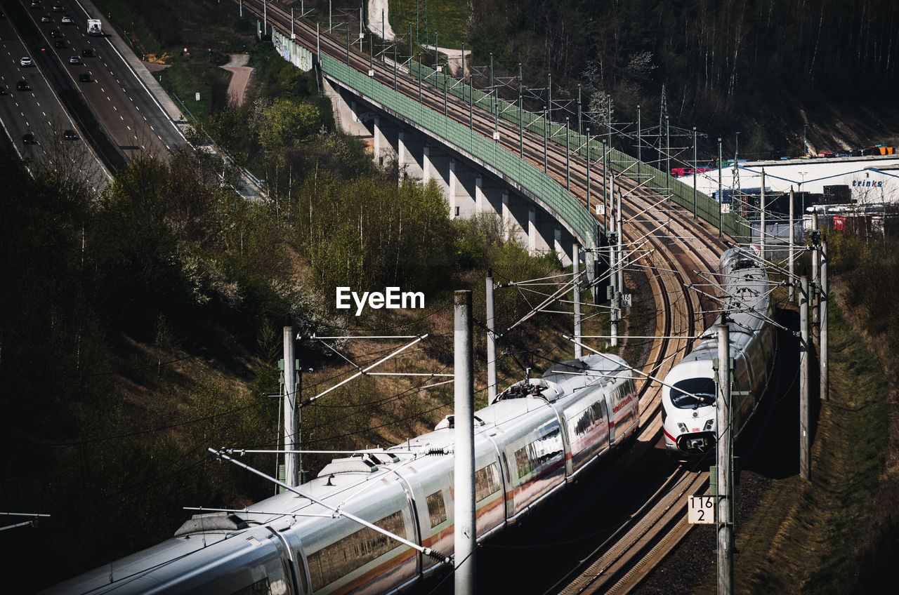 HIGH ANGLE VIEW OF TRAIN AT RAILROAD BRIDGE