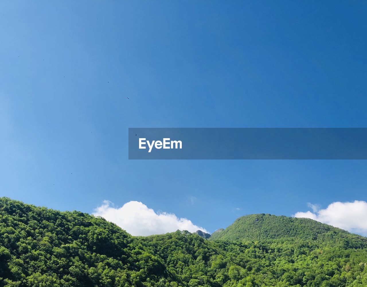 Low angle view of mountain against blue sky