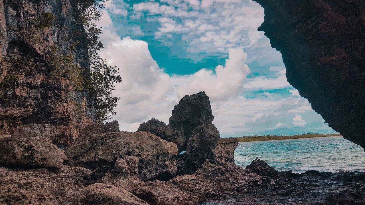 PANORAMIC VIEW OF SEA AND ROCK FORMATIONS AGAINST SKY