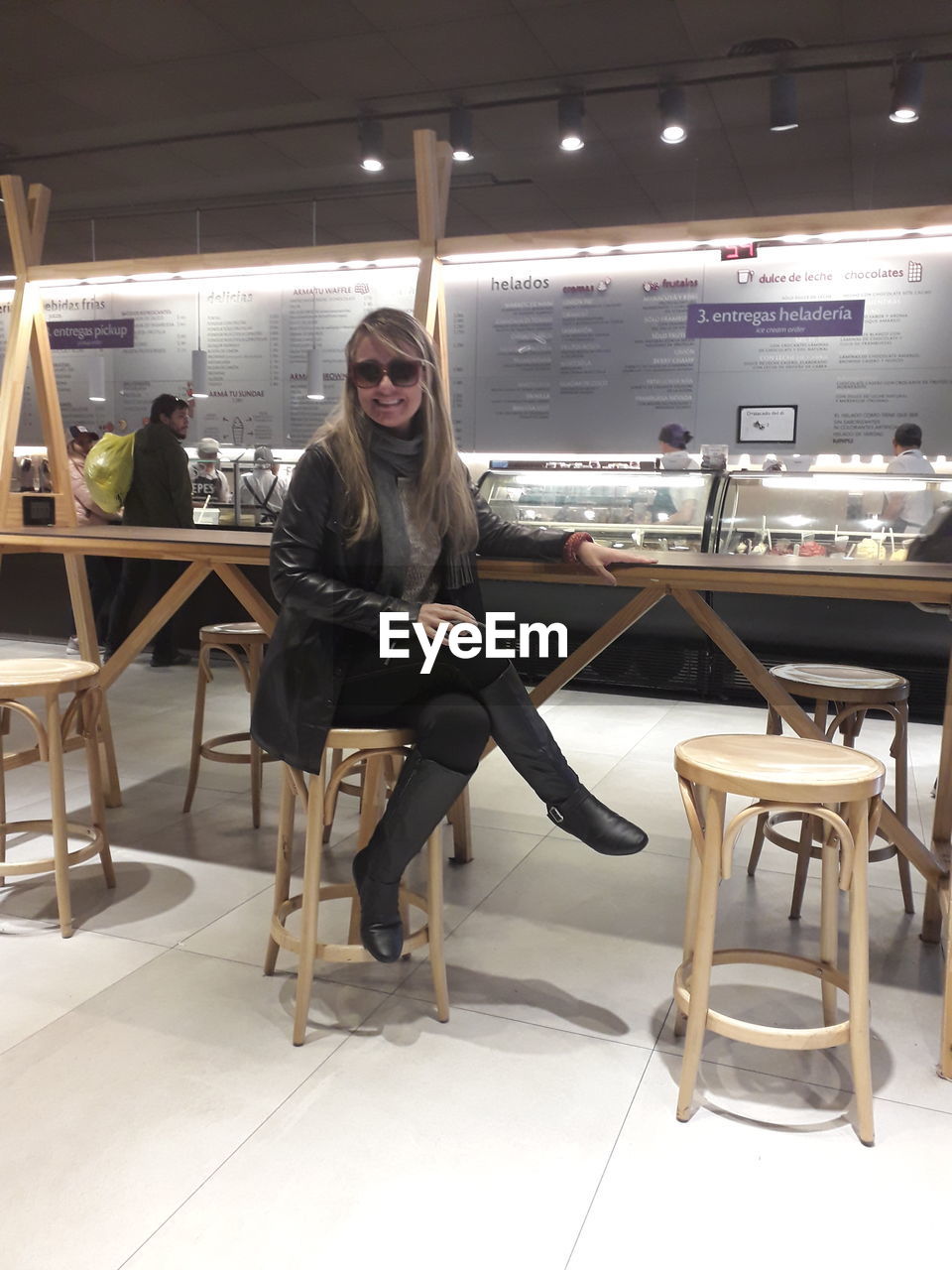 Portrait of woman sitting on chair in restaurant