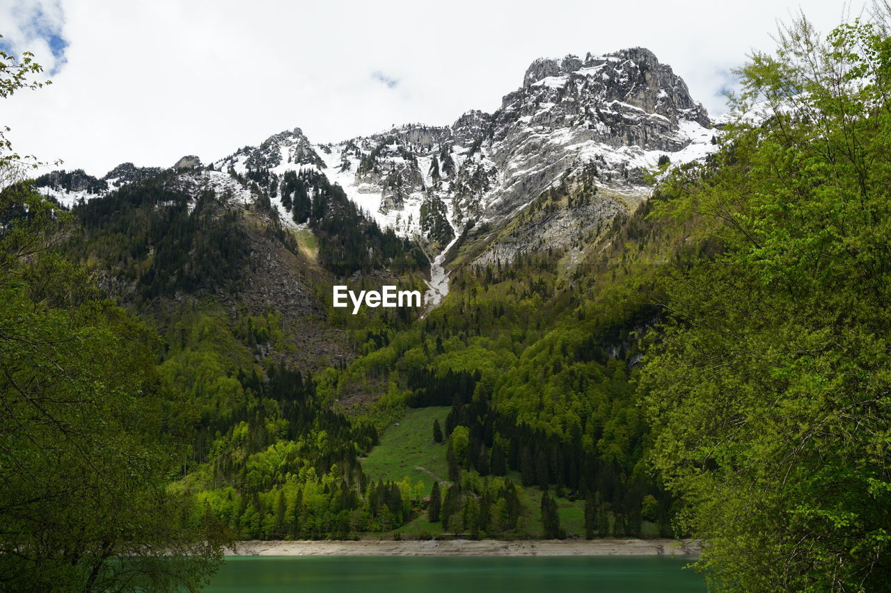 Scenic view of lake and mountains against sky