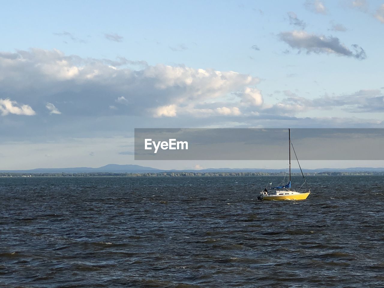 VIEW OF SAILBOAT IN SEA AGAINST SKY