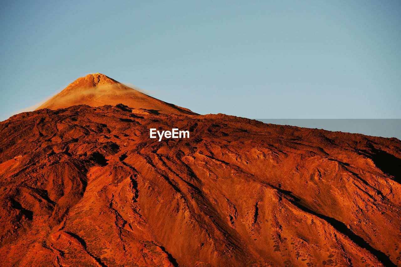 Scenic view of rocky mountain at el teide national park against clear sky