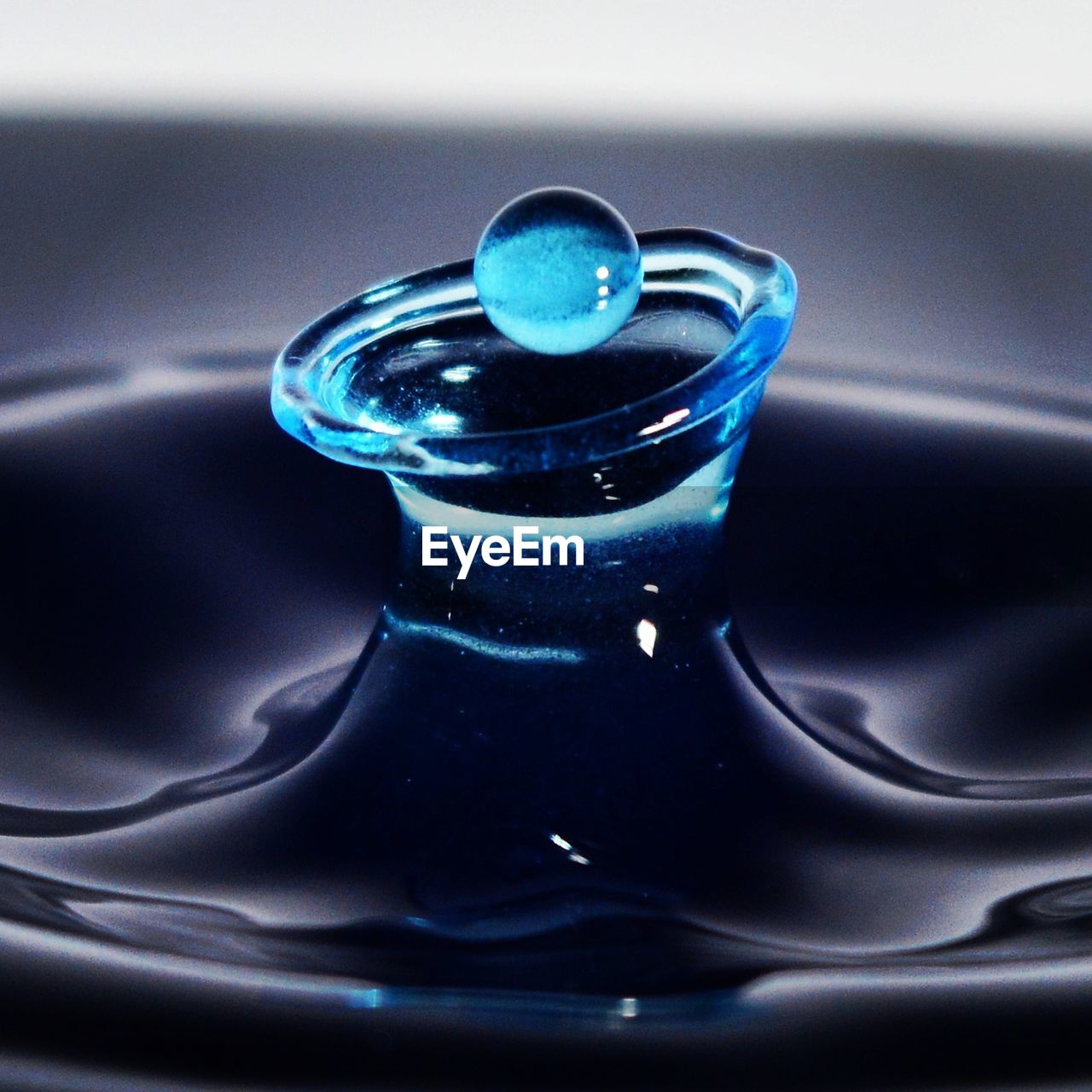 Close-up of blue splash crown in drink