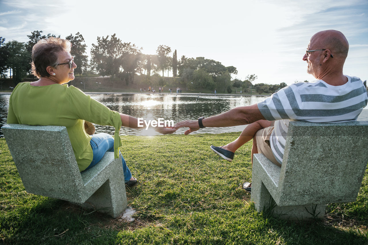 Retired couple holding hands watching the sunset