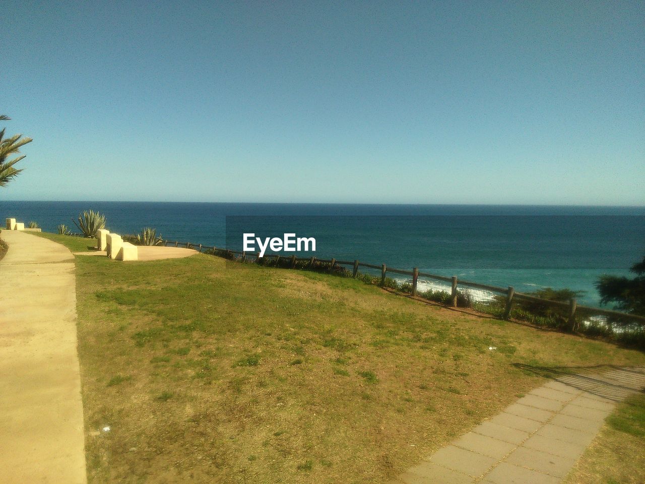 SCENIC VIEW OF BEACH AGAINST CLEAR BLUE SKY