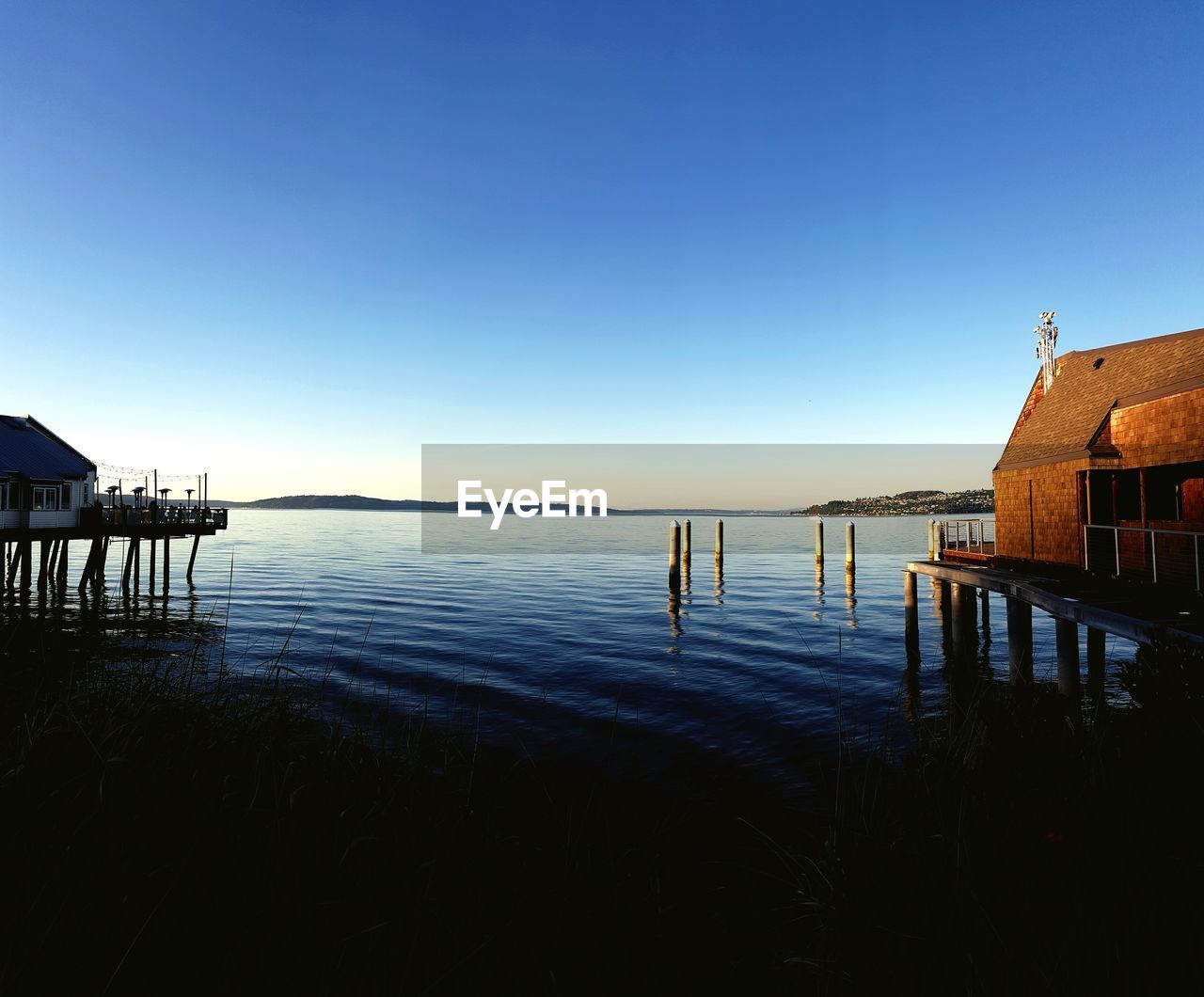 Calm blue sea against clear sky