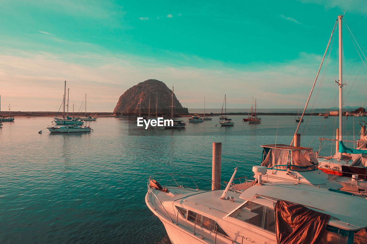 SAILBOATS MOORED IN BAY