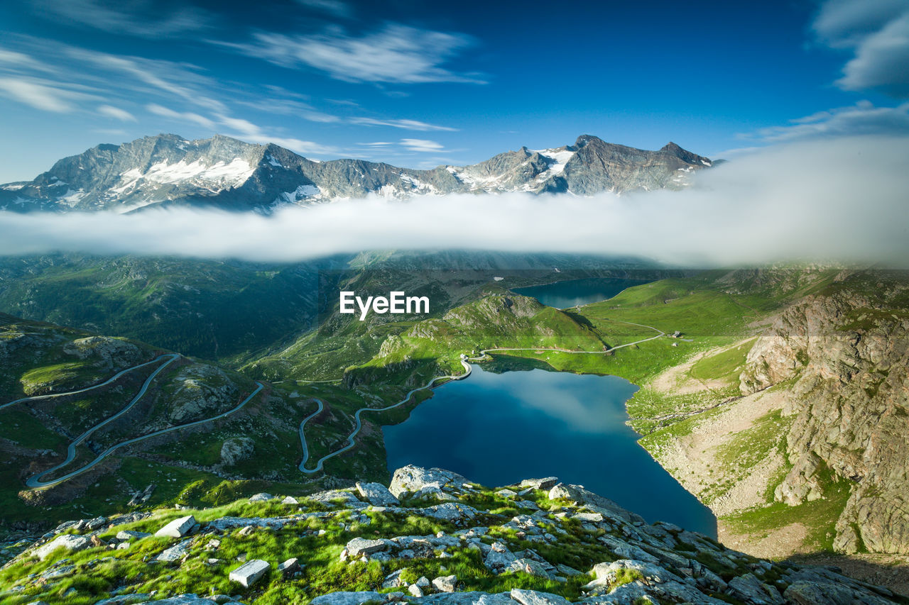 Scenic view of mountains against blue sky