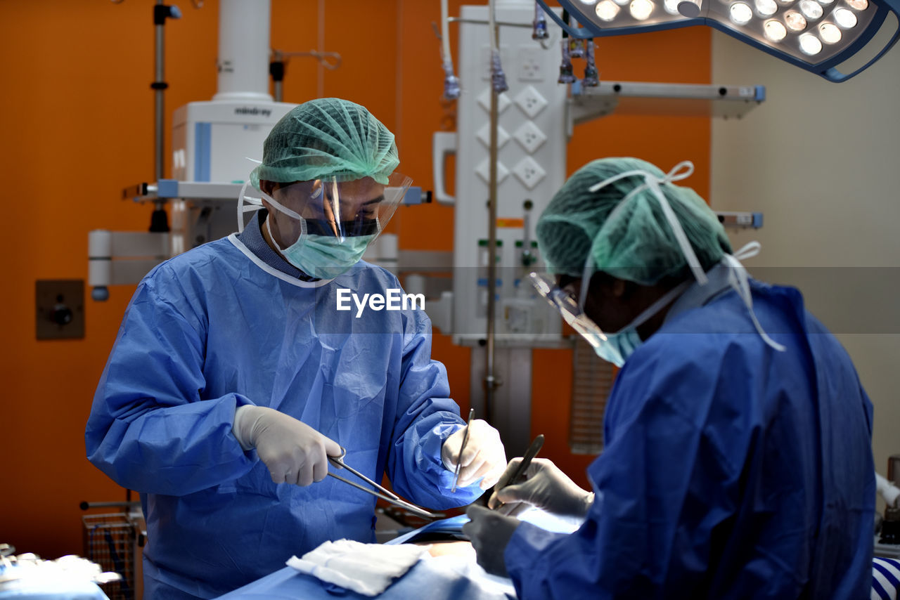 Doctors performing surgery in operating room