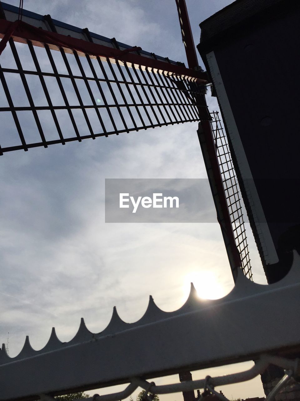 Low angle view of traditional windmill against sky