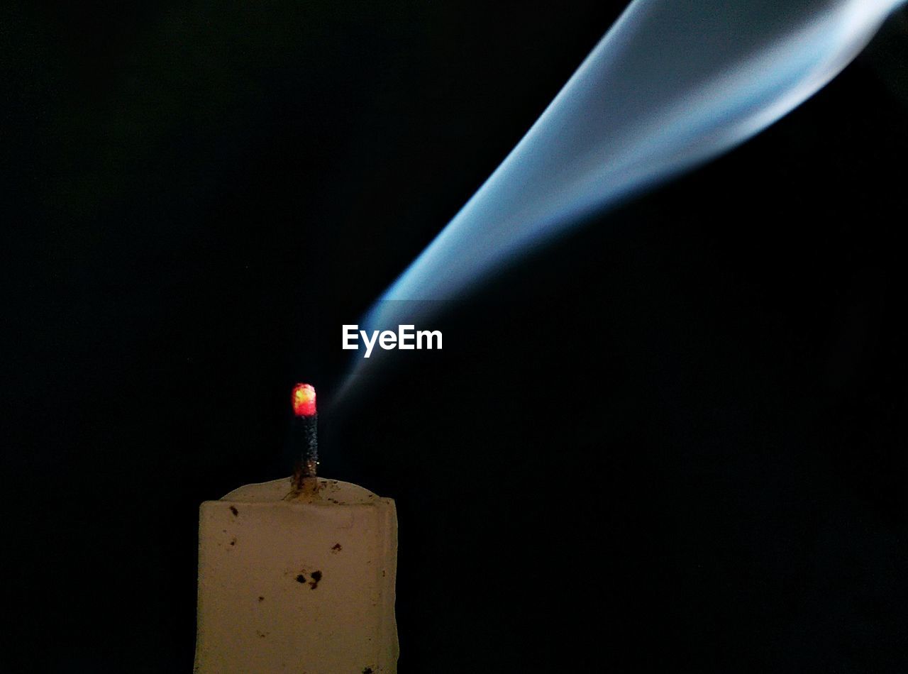 Close-up of smoke emitting from burnt candle