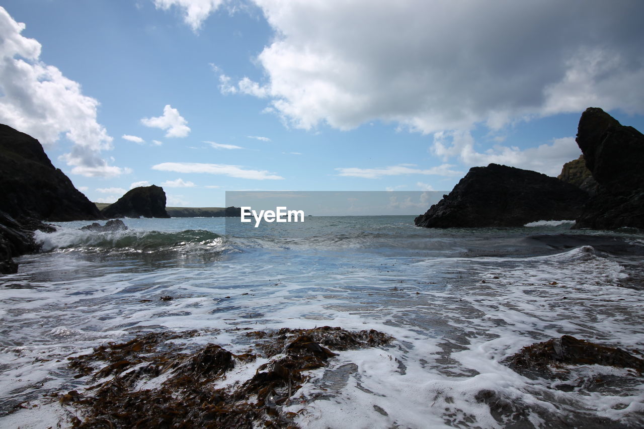 Scenic view of sea against cloudy sky