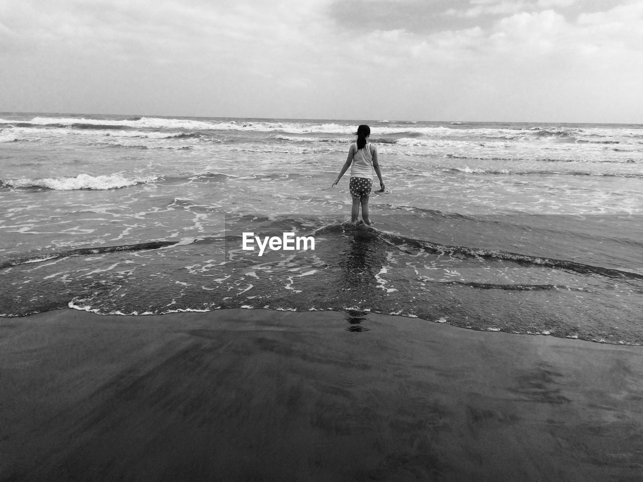 Woman on beach against sky