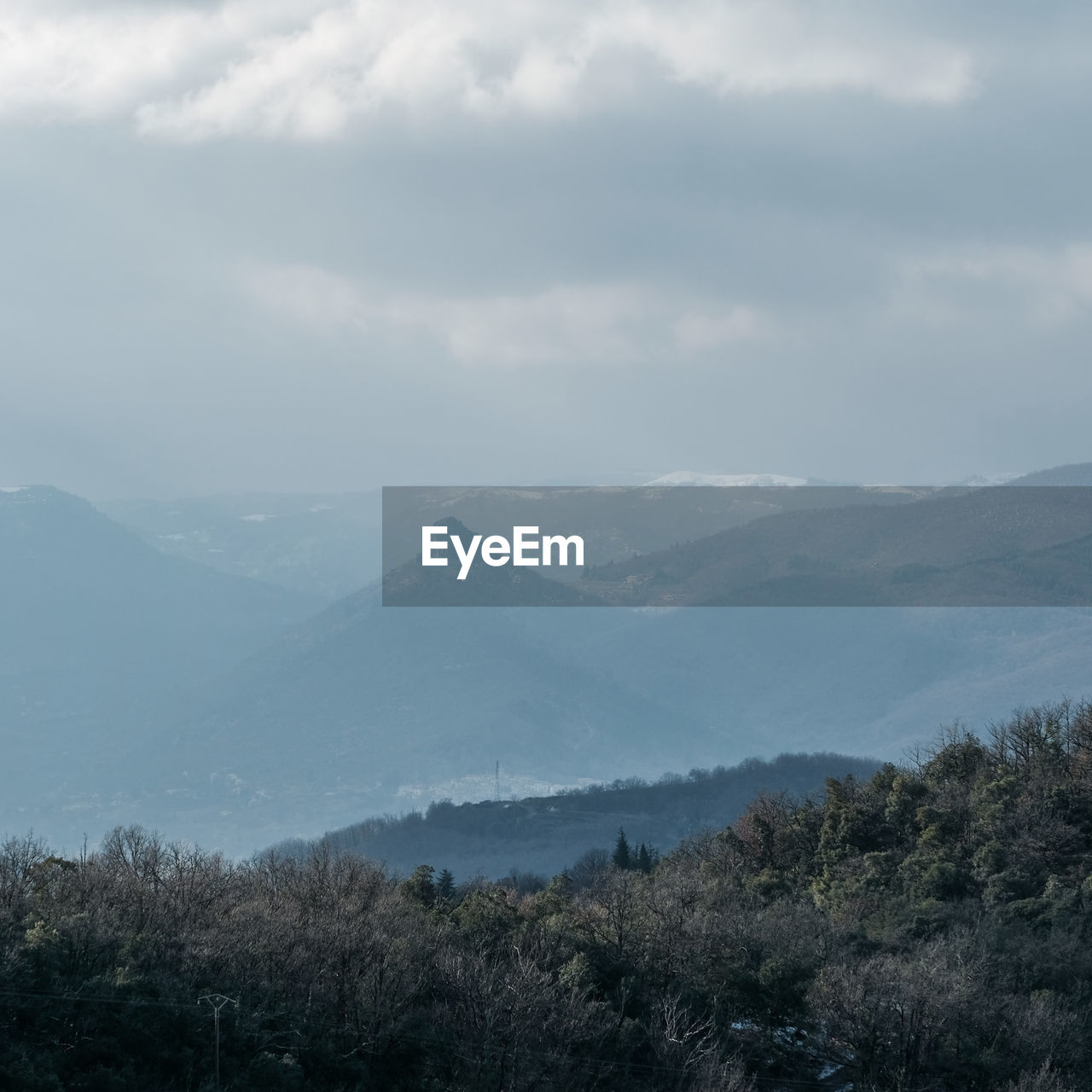 CLOUDY SKY OVER MOUNTAINS