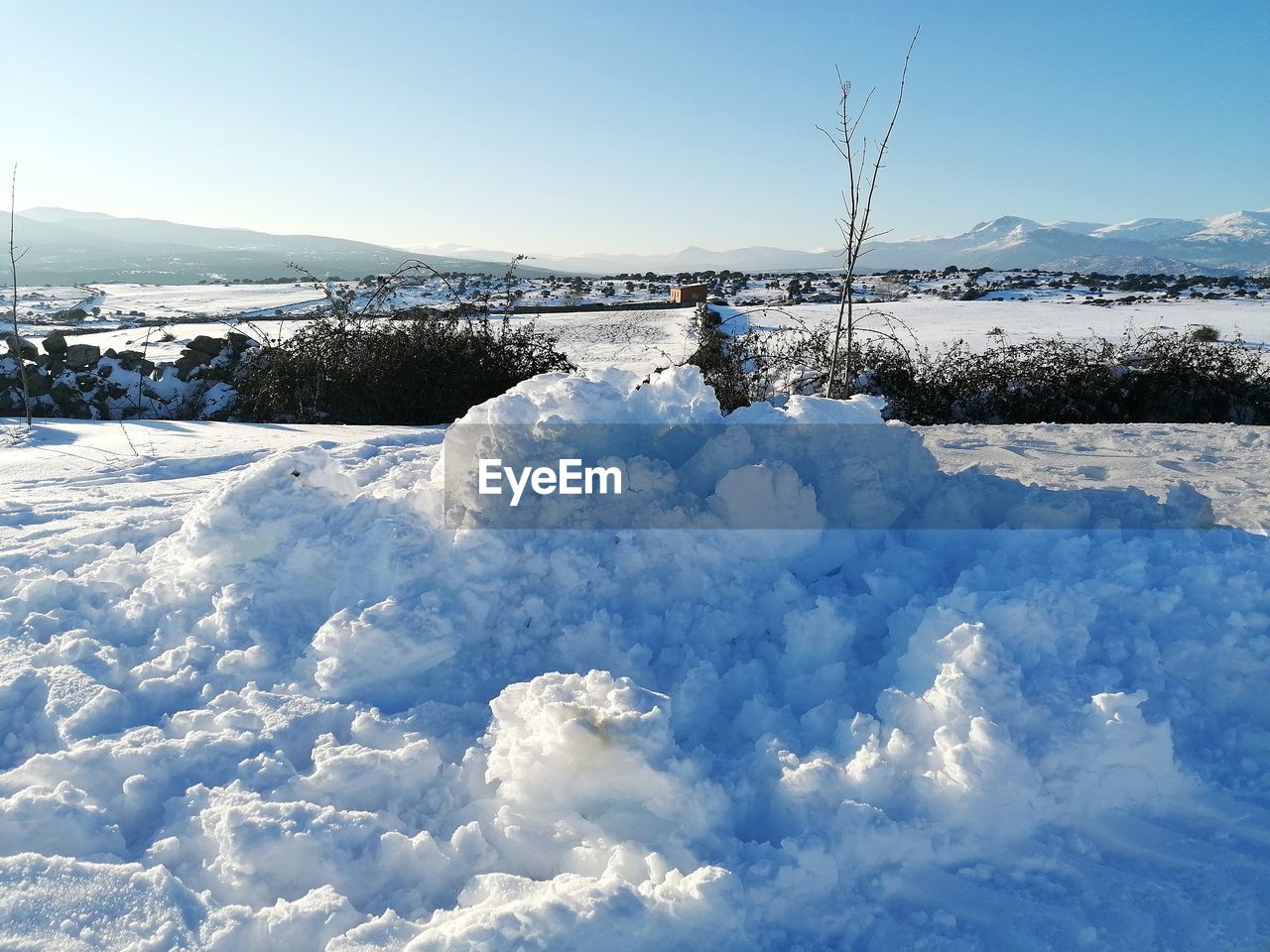 Person skiing on snow covered land against sky