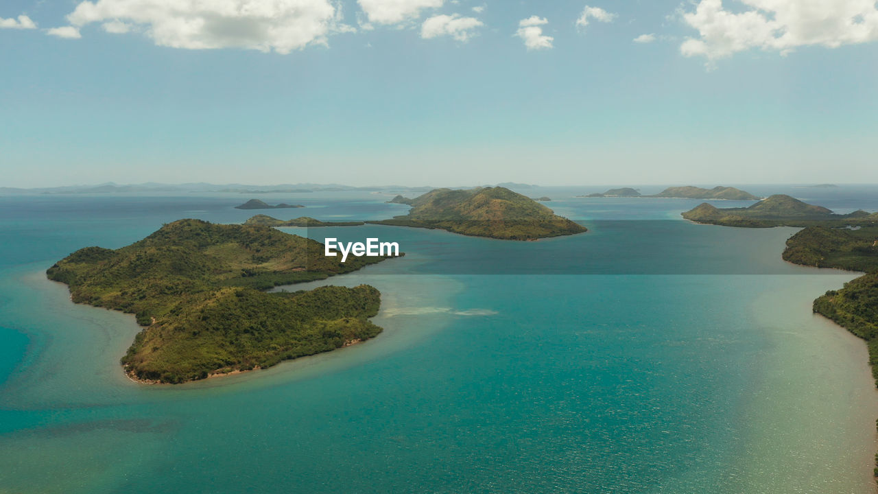 Small island group in province of palawan.  seascape, islands covered with forest, sea 