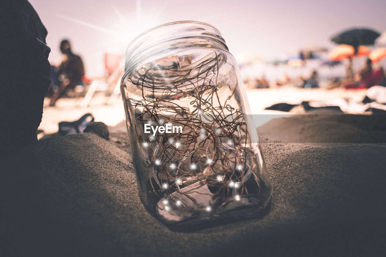  glass jar  on the sand 