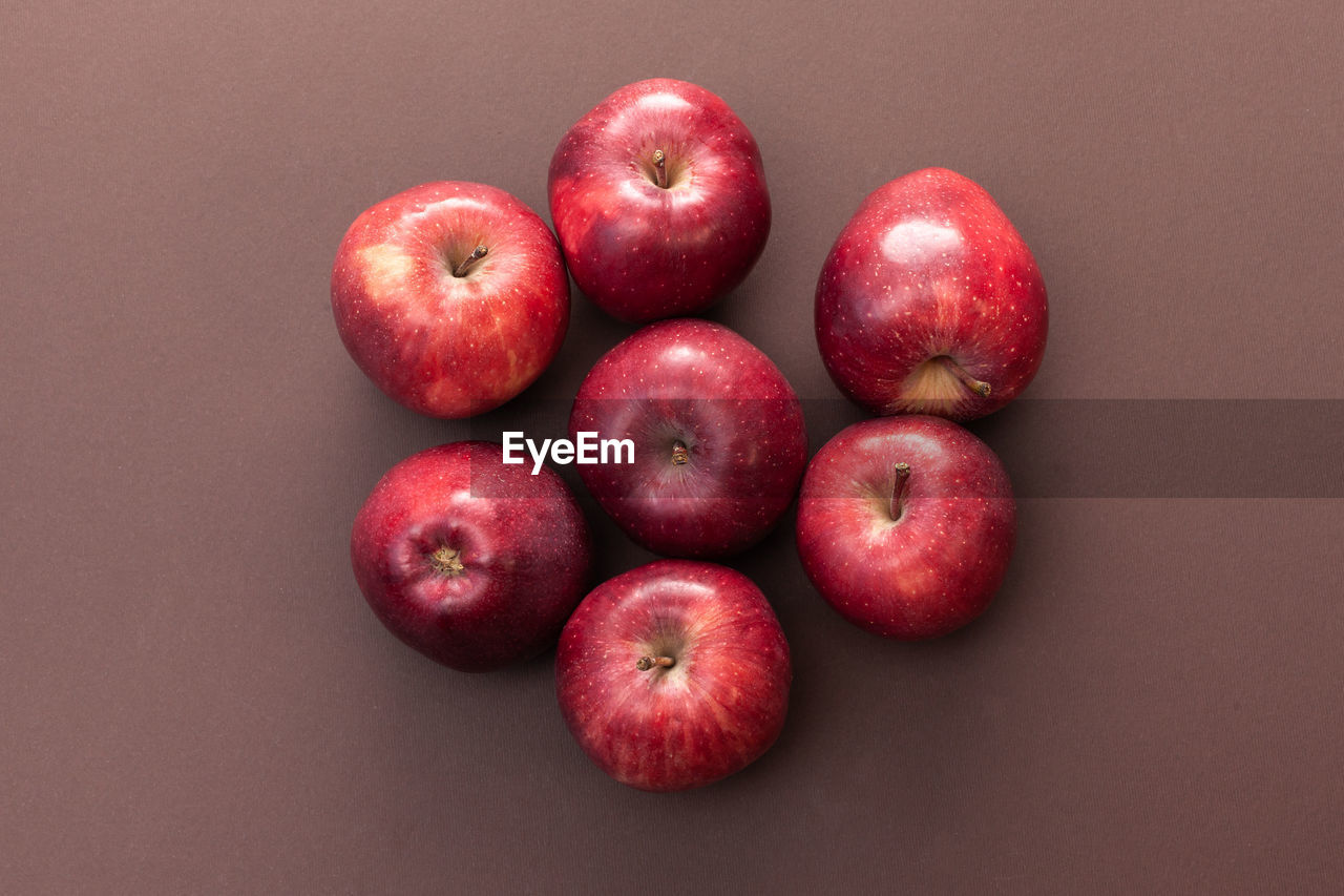 healthy eating, food and drink, fruit, food, wellbeing, freshness, plant, red, apple, produce, studio shot, apple - fruit, group of objects, no people, indoors, colored background, still life, close-up, large group of objects, directly above, pink, high angle view, cut out, organic, ripe