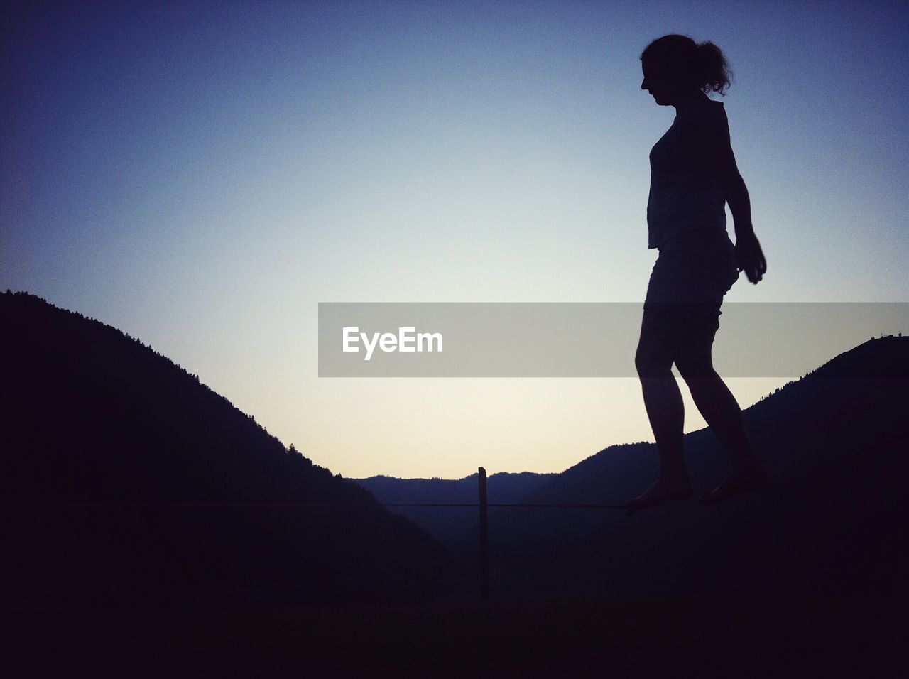 SILHOUETTE WOMAN STANDING AGAINST SKY