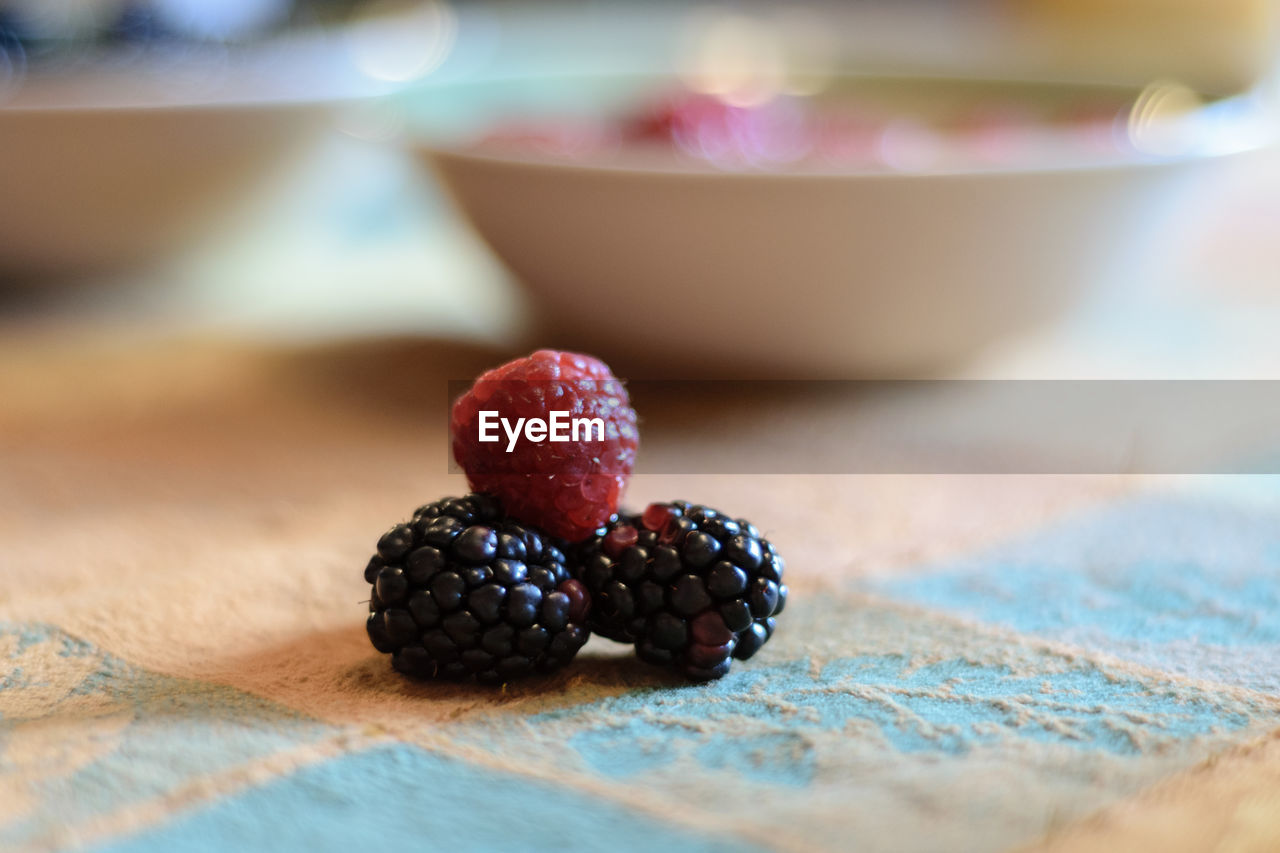 CLOSE-UP OF STRAWBERRY IN CONTAINER ON TABLE