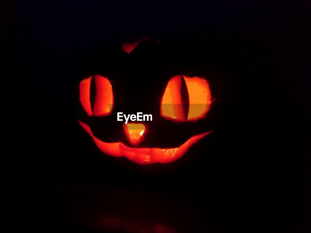 Close-up of illuminated jack o lantern against black background