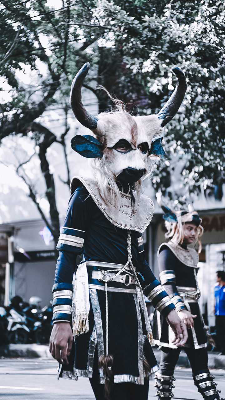 FULL LENGTH OF PERSON WEARING MASK ON UMBRELLA