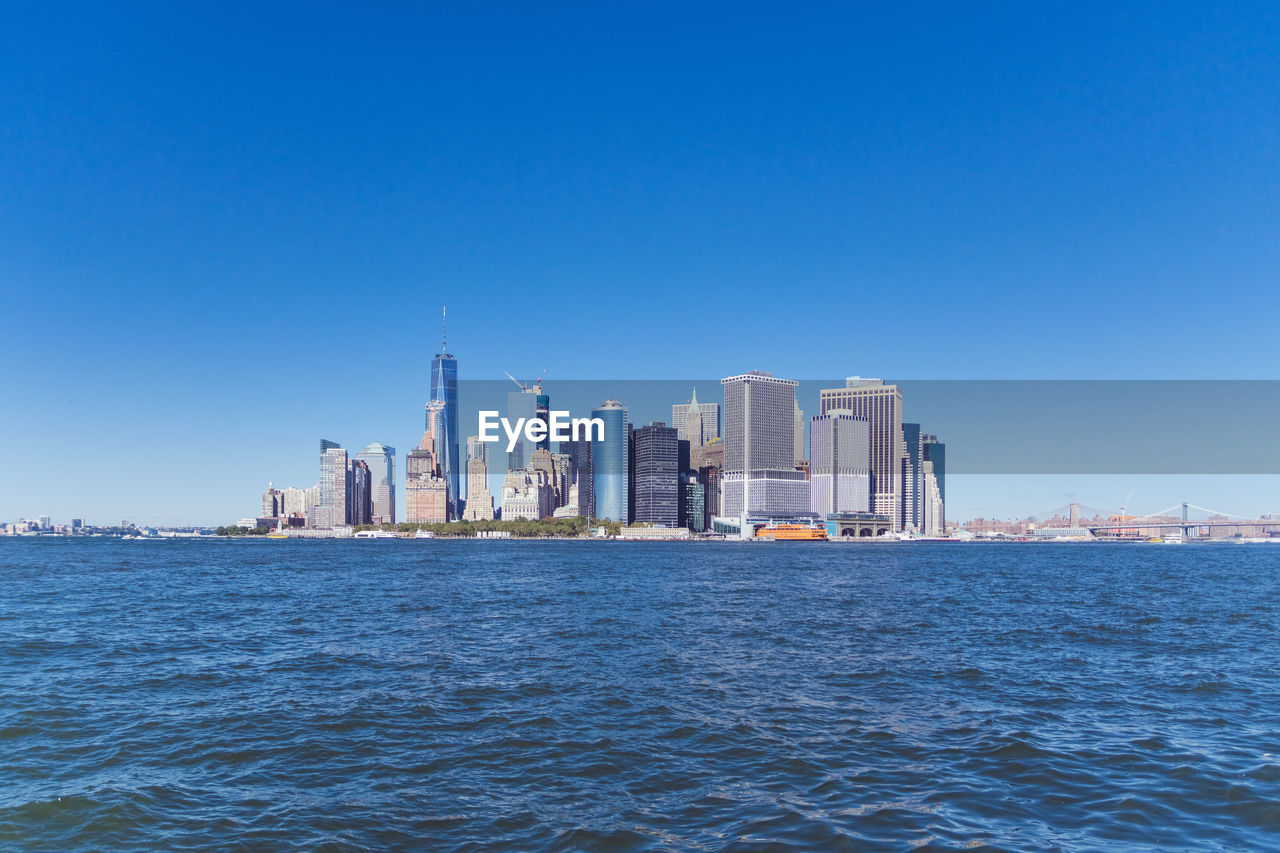 City skyline against clear blue sky